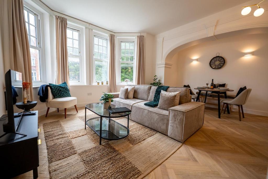 a living room with a couch and a table at Charming coastal escape in Eastbourne