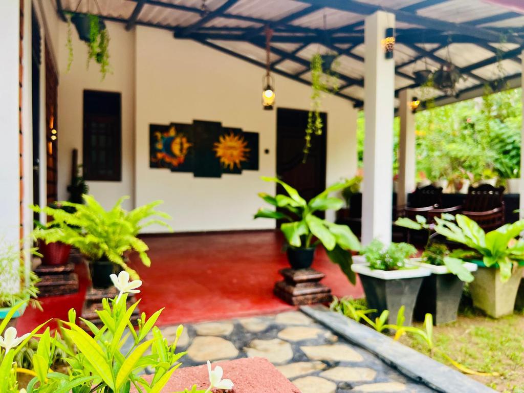 a patio with a bunch of potted plants at Sea Paradise Hidden Villa in Tangalle