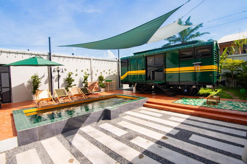 a house with a swimming pool and a train at Baan Rot Fai Krabi Platform 2 in Ao Nam Mao