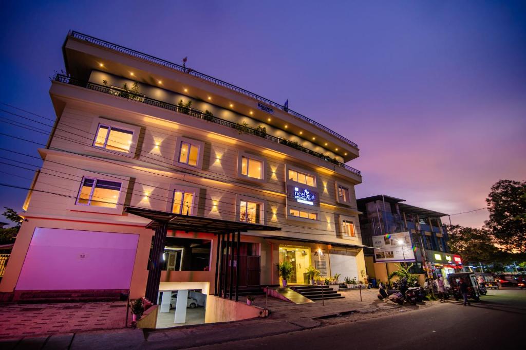 a tall building with lights on top of it at Neelagiri Heritage Hotel - Near Calicut Railway Station in Kozhikode
