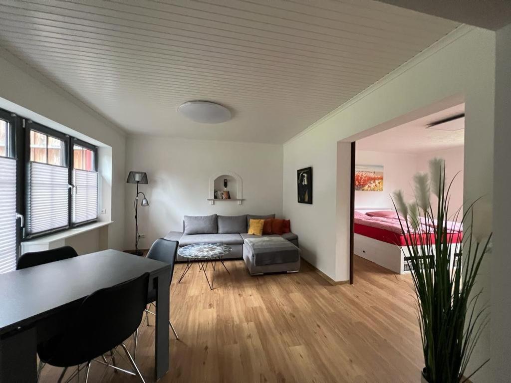 a living room with a couch and a bed and a table at Gemütliche Ferienwohnung in Hüttblek in Hüttblek