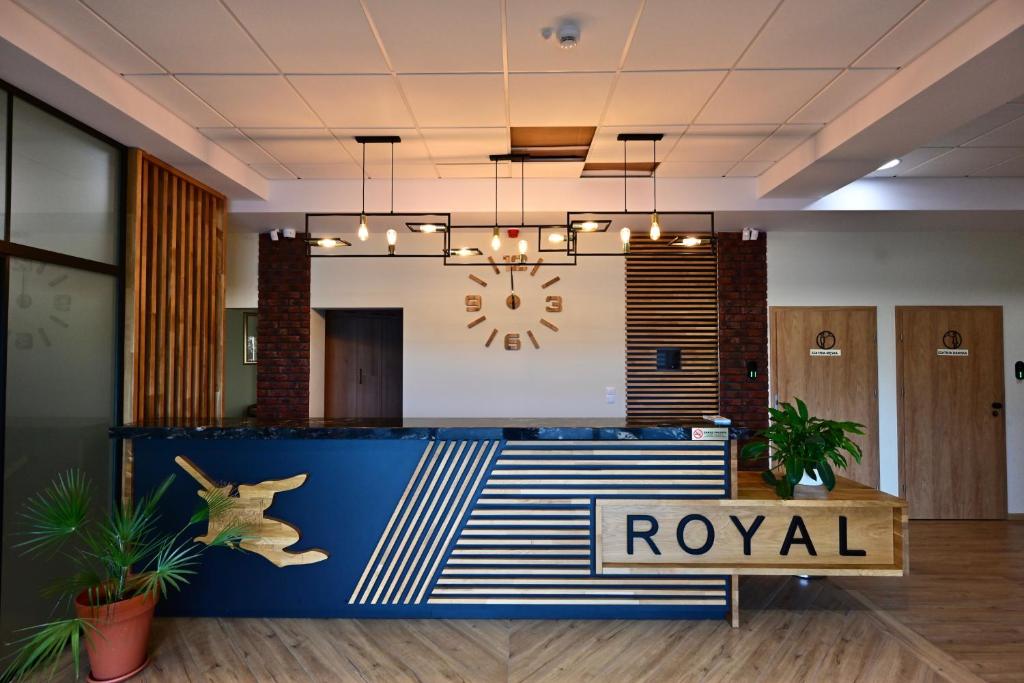 a lobby with a royal sign and a reception desk at Stay at Royal Kraków Golf in Ochmanów