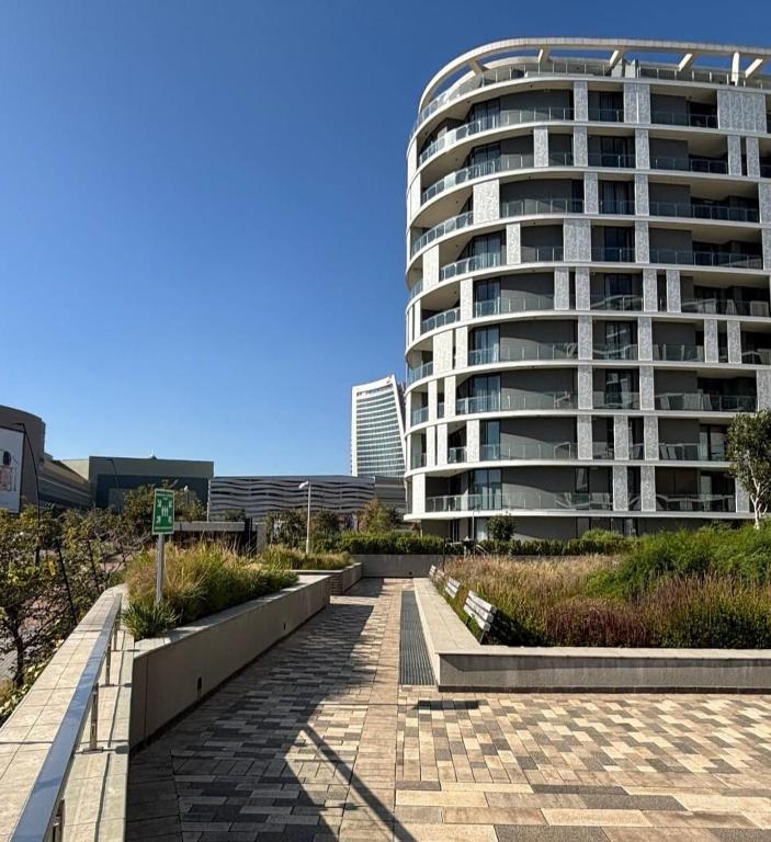 a building with a walkway in front of a building at Ellipse Luxurious Tamarind Green Studio Experience in Midrand