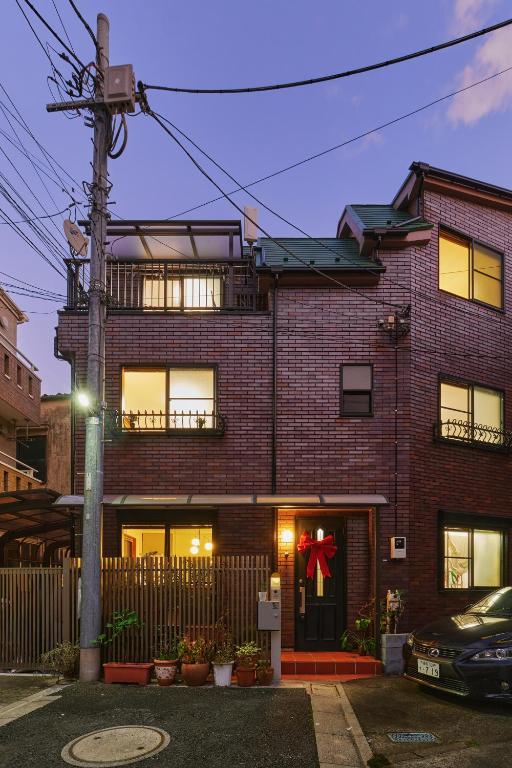 a brick house with a christmas bow on it at Yotsuya Lantern - Private 3 stories house for family in Tokyo