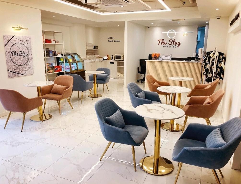 a waiting room with tables and chairs in a store at The Stay Nangman Seongseo in Daegu