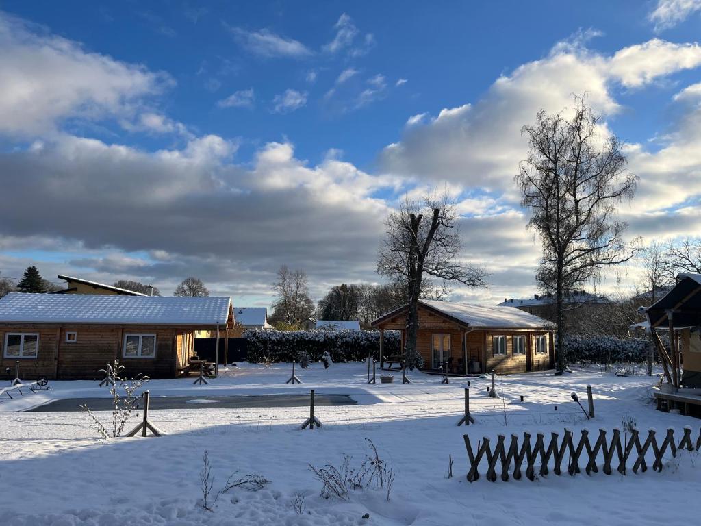 a house in the snow with a fence at Ô Village in Giromagny