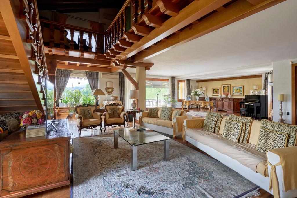 a living room with couches and a piano at Dream's hill in San Pietro di Feletto