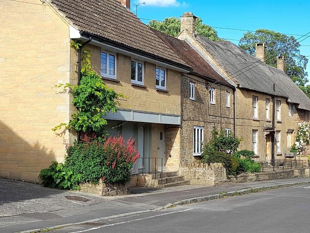 a row of brick houses on the side of a street at Greenham Rise in Chiselborough