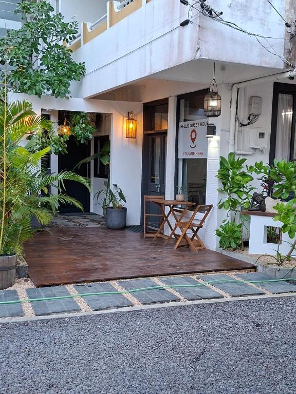 a building with a wooden deck in front of it at Hello Tourist Residence in Quatre Bornes