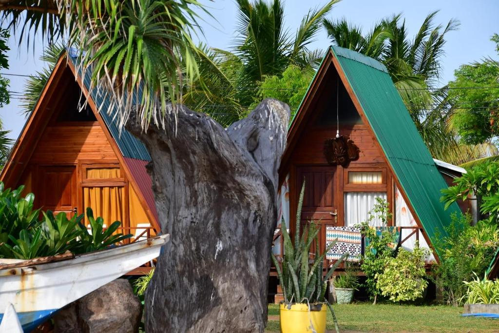 a house with a boat in front of it at Thats why beach hotel in Trincomalee