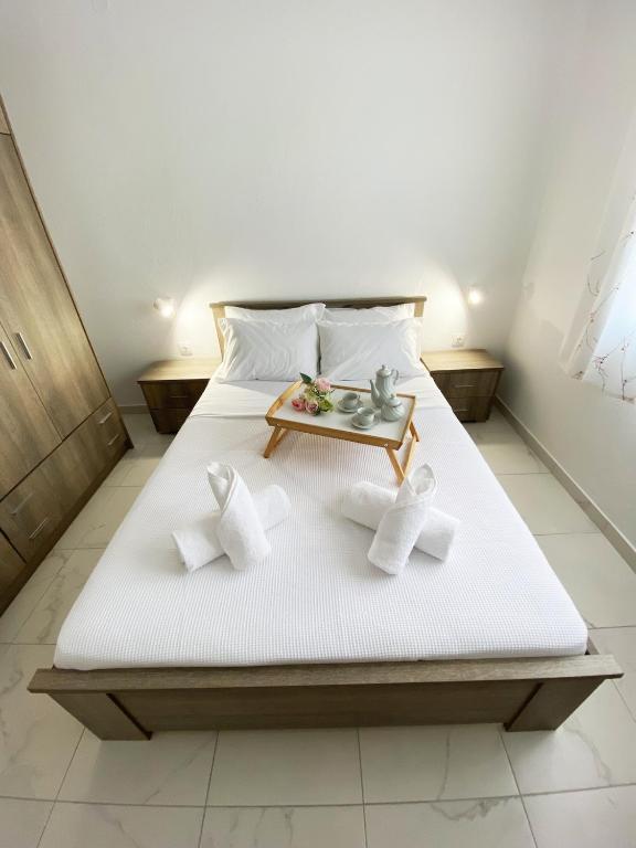 a bedroom with a bed with a tray on it at Sadin apartment in Neos Marmaras