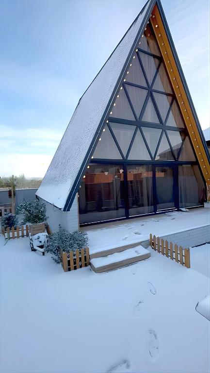 a house under construction with a pitched roof at A-frame evlər-I in Qusar
