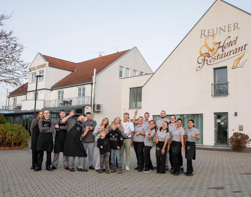 un groupe de personnes posant une photo devant un bâtiment dans l'établissement Flair Hotel Reuner, à Zossen