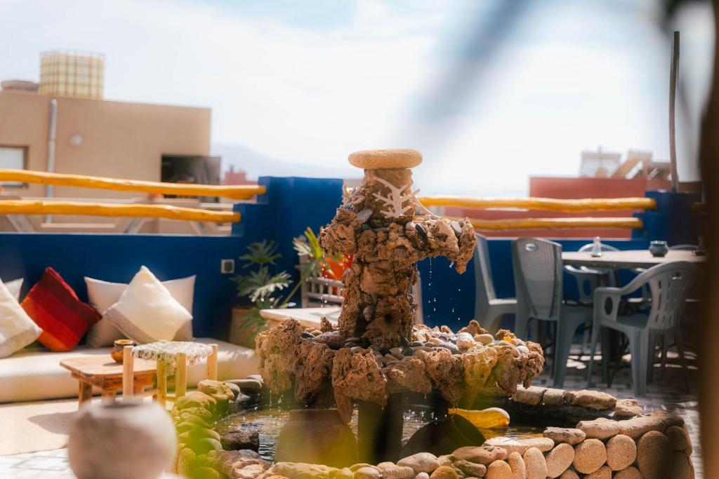 a table topped with a statue of a tree at Light House Imsouane in Imsouane