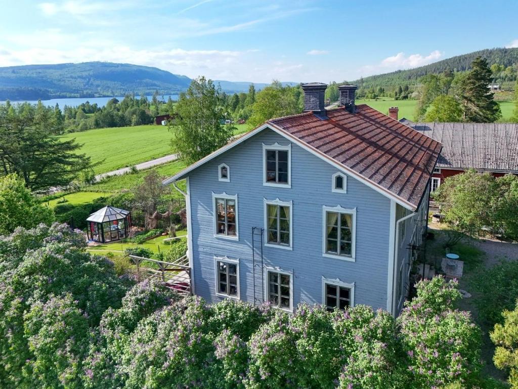 an aerial view of a blue house on a hill at Norrgården Hälsingland in Vallsta