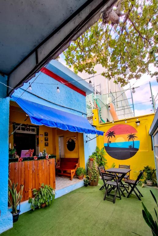 a colorful house with a patio with a table at Hostel Dragão do Mar Fortaleza in Fortaleza