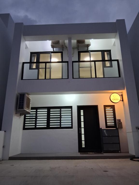 a building with a clock on the side of it at Starry Night Travel Homestay in Magong
