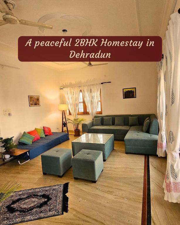 a living room with blue couches and a sign at Ashiana By Ijabojyu- Pet friendly Homestay in Dehradun