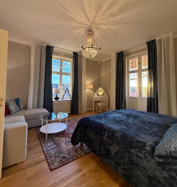 a bedroom with a bed and a living room at Villa Thurdus in Härnösand