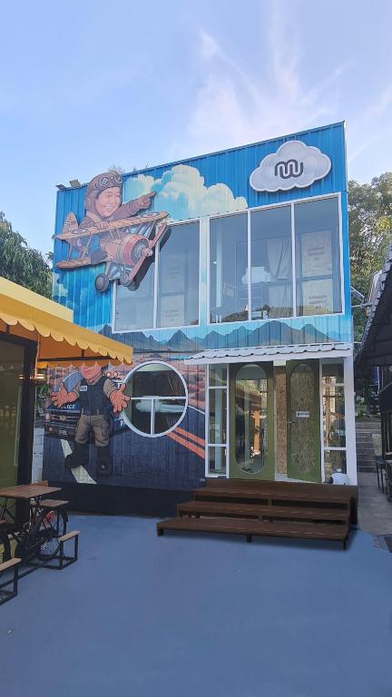 a building with a mural on the side of it at Sleep On The Clouds in Ban Kata