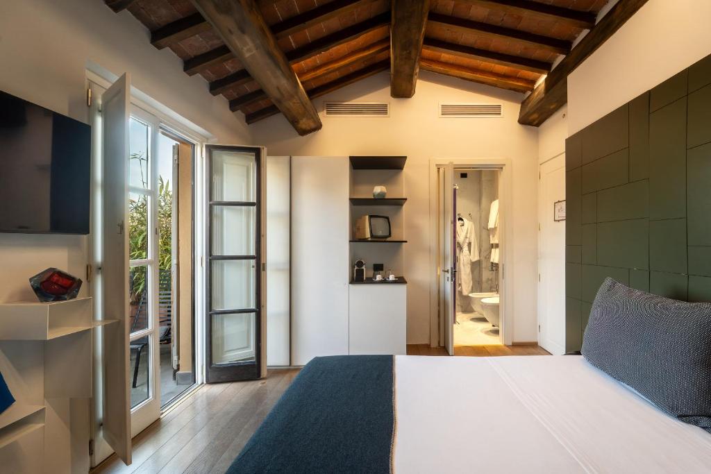 Postel nebo postele na pokoji v ubytování Hotel Milu Florence