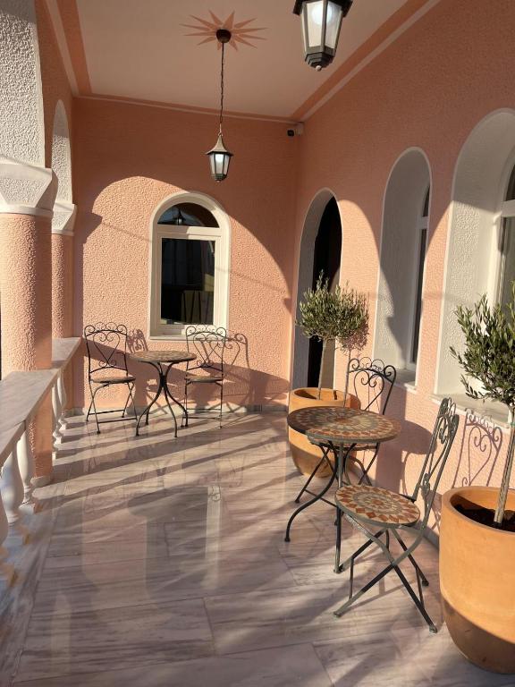 a patio with tables and chairs in a building at The Residence Myrina in Myrina