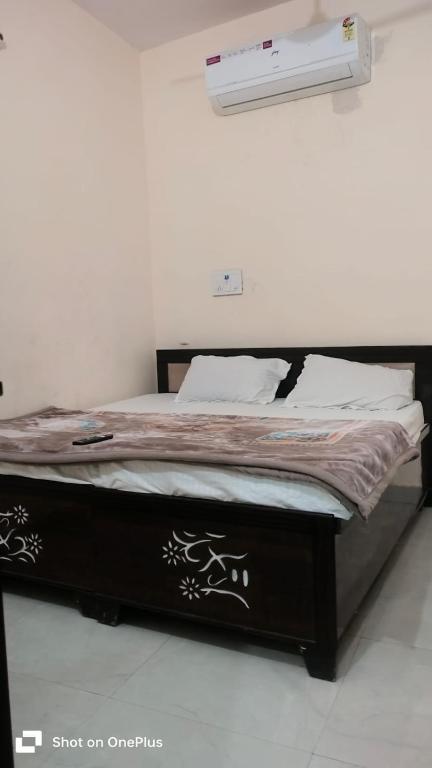 a bed with a black and white comforter in a room at Hotel Aarav Inn in Pānīpat