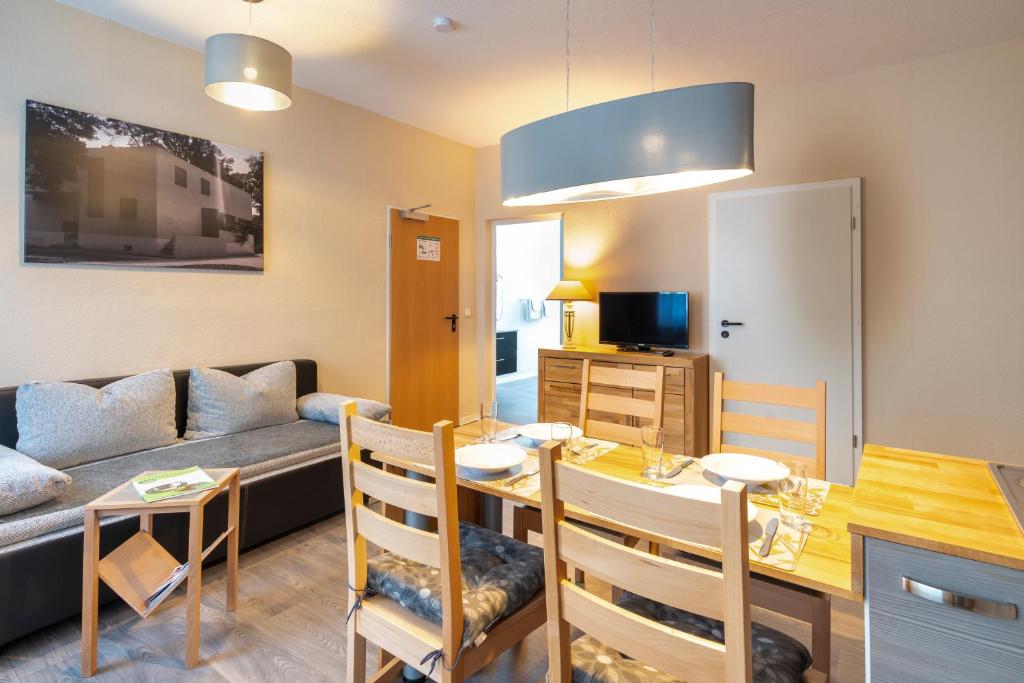 a living room with a table and a couch at Pension am Pollingpark Haus II in Dessau