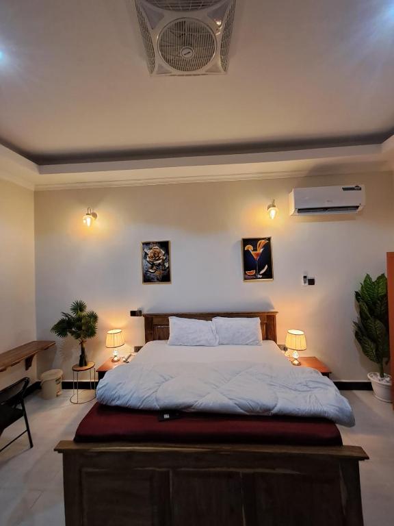a bedroom with a bed and two lamps and a piano at Serengeti space resort in Bunda