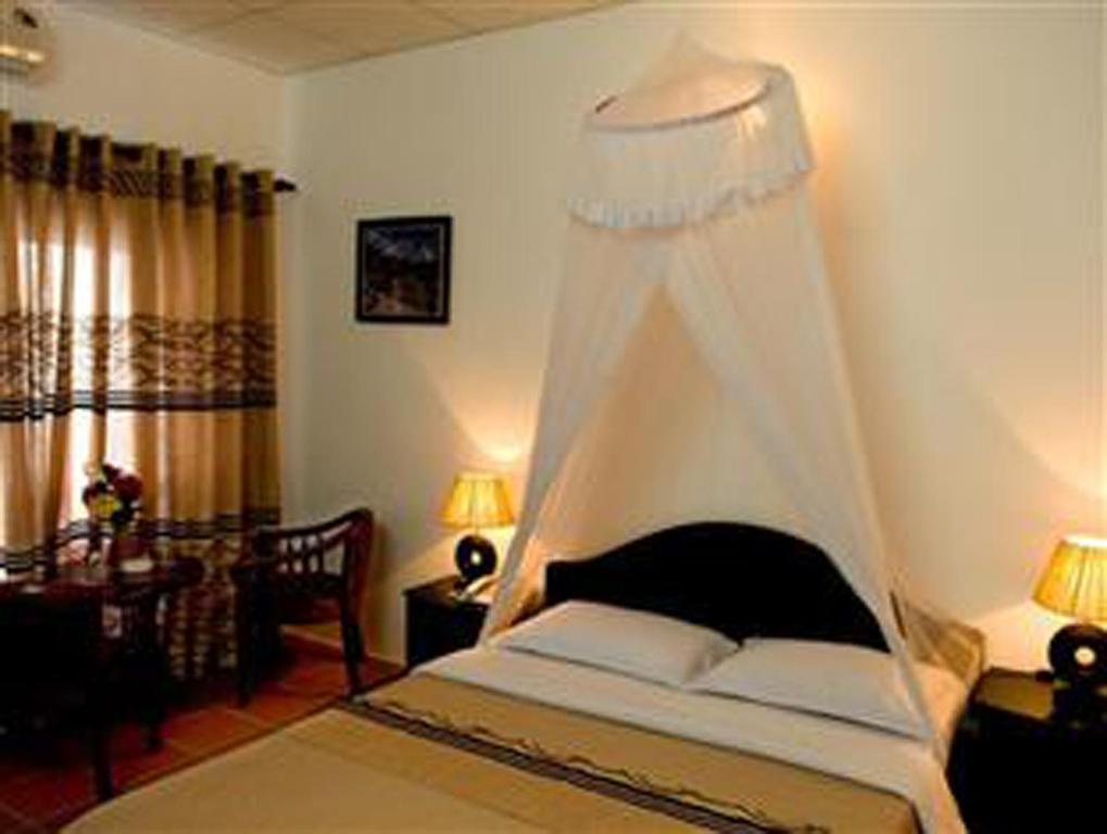 Giường trong phòng chung tại Lotus Village Resort