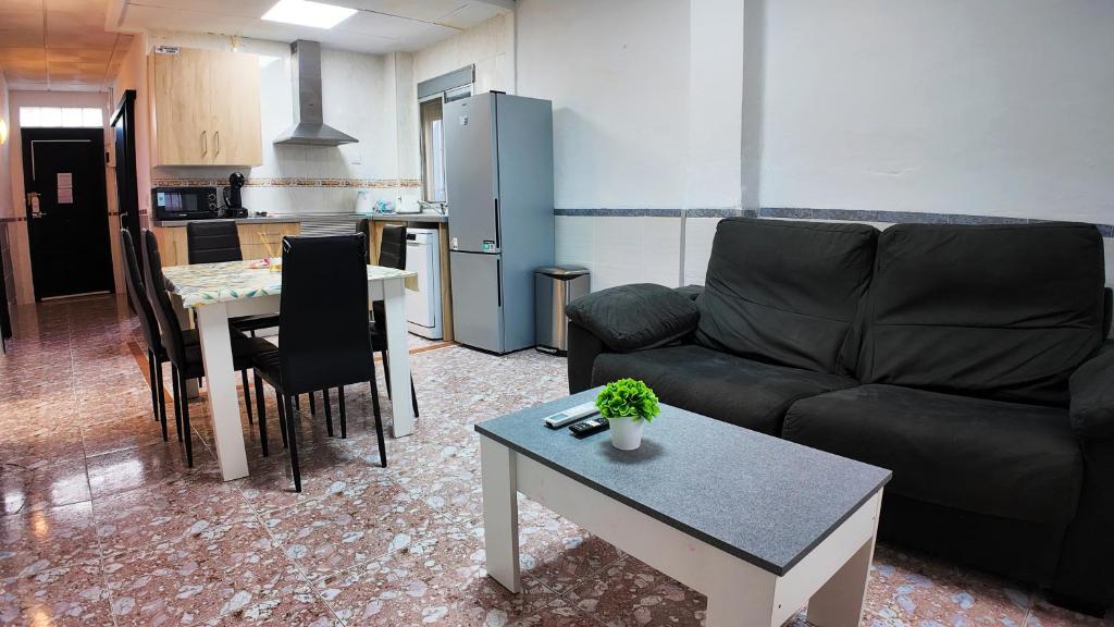 a living room with a couch and a table at Apartalux Playa Arenal in Burriana