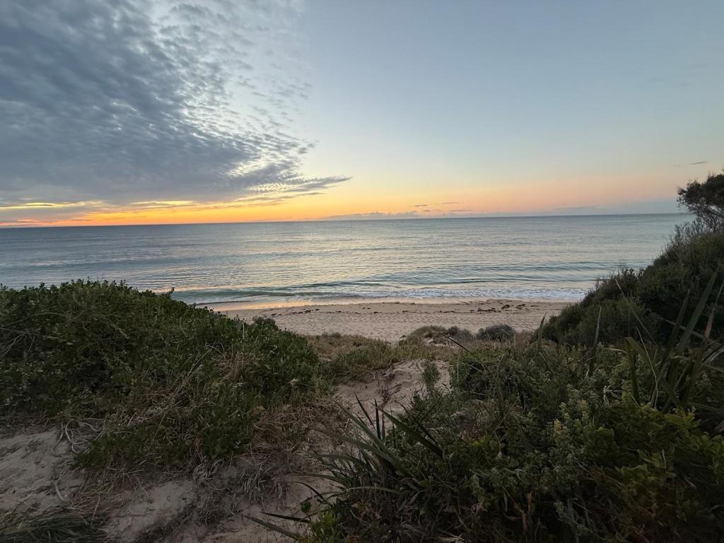 a view of the ocean from a beach at sunset at Ocean Whisper in Wannanup