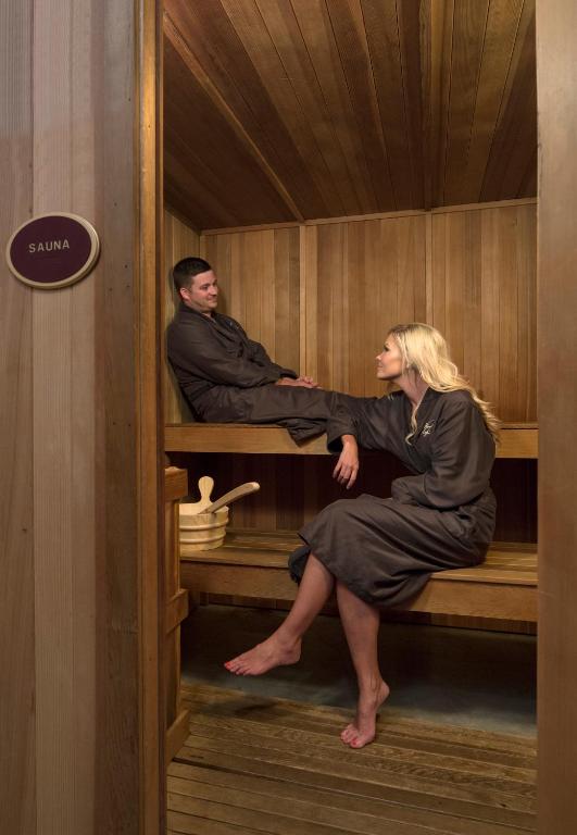 a man and a woman sitting in a sauna at Carnegie Hotel & Spa in Johnson City