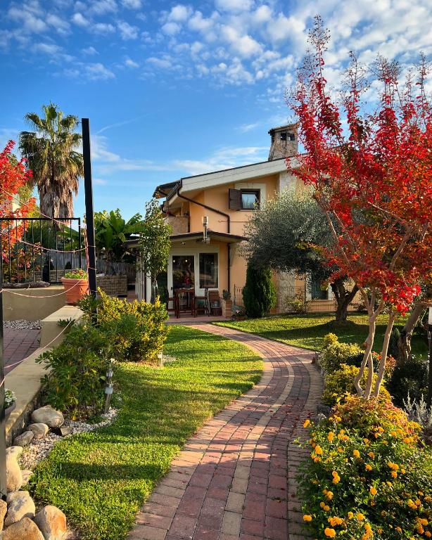 a house with a brick walkway in a yard at Peperosa in collina B&B in Pescara
