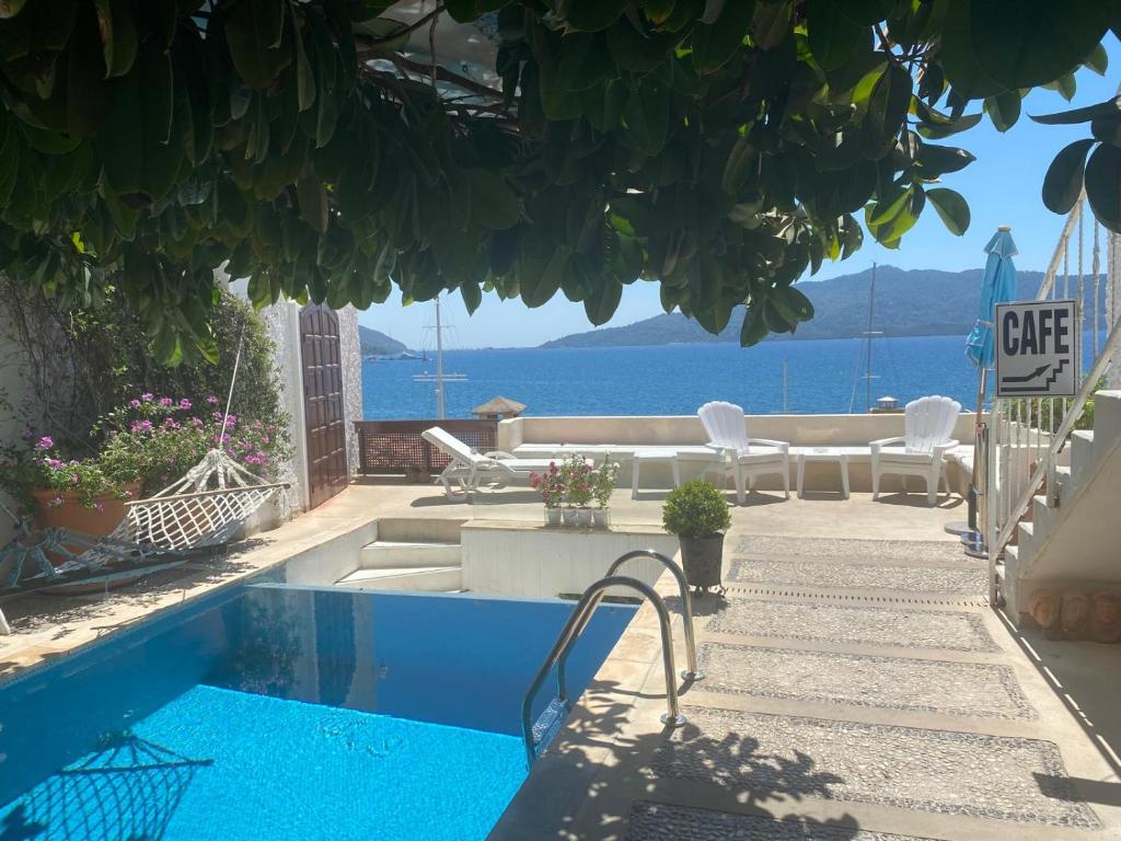 a house with a swimming pool with a view of the ocean at Castle81homes White , Sea view house in Marmaris