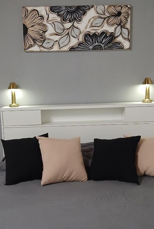 a bed with two lamps on top of it at Merlo mar 2 in Merlo