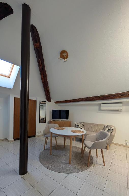 a living room with a table and chairs at Ascona, Casa Collegio - im Zentrum, am See Lago Maggiore in Ascona