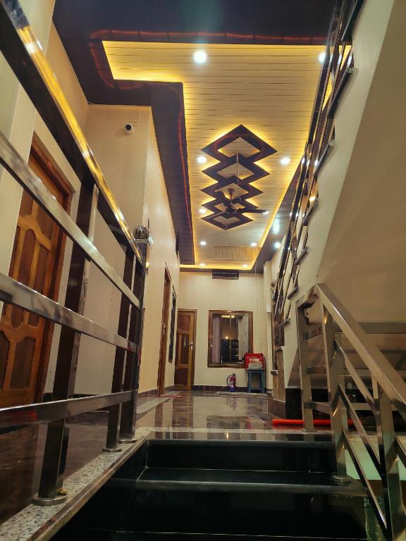 a hallway with stairs and a ceiling with lights at Akshayavat Palace in Ayodhya