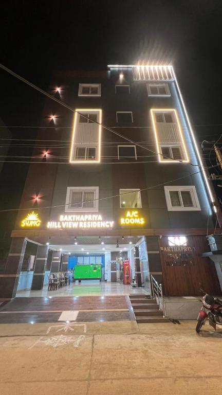a building with a tennis court in front of it at night at Bakthapriya HILL VIEW RESIDENCY in Srikalahasti