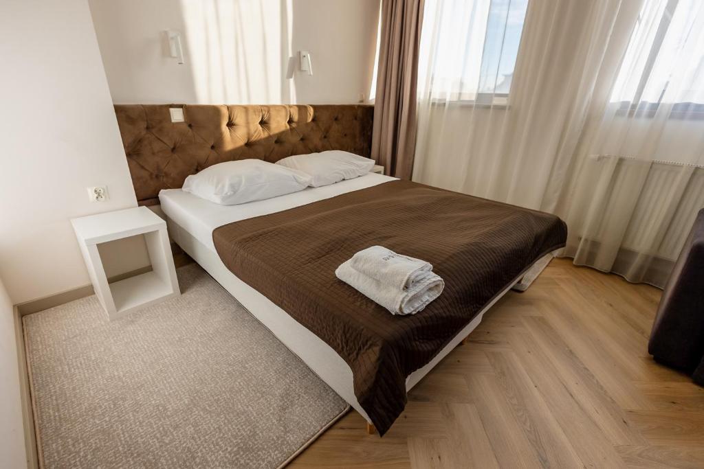 Säng eller sängar i ett rum på Hotel Wena