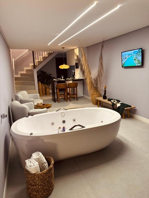 a large white bath tub in a living room at Mahalo Exclusive Boutique in Maragogi
