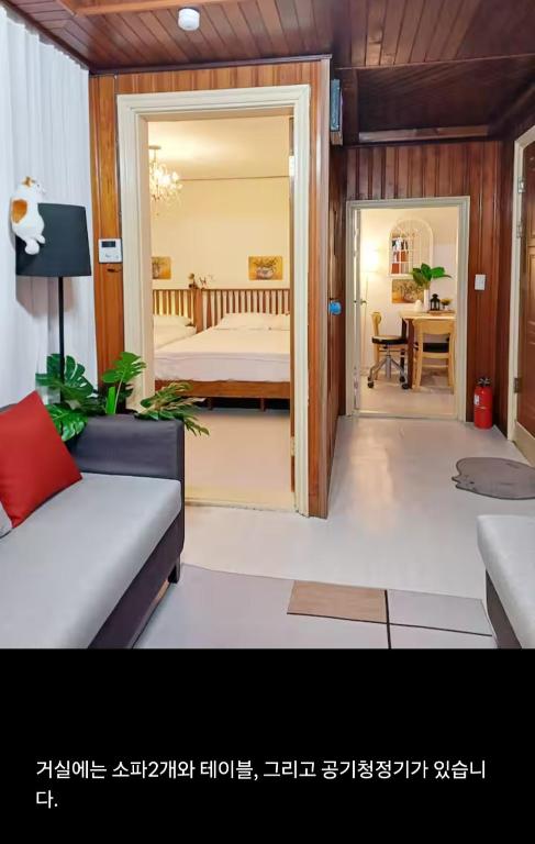 a living room with a couch and a bed in a room at Urban in Suwon