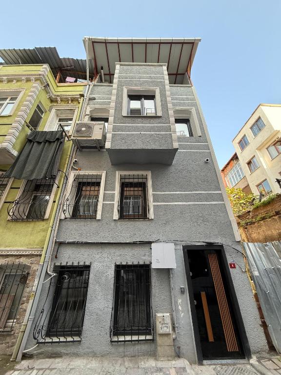 a tall gray building with barred windows on it at Atay Apart in Istanbul