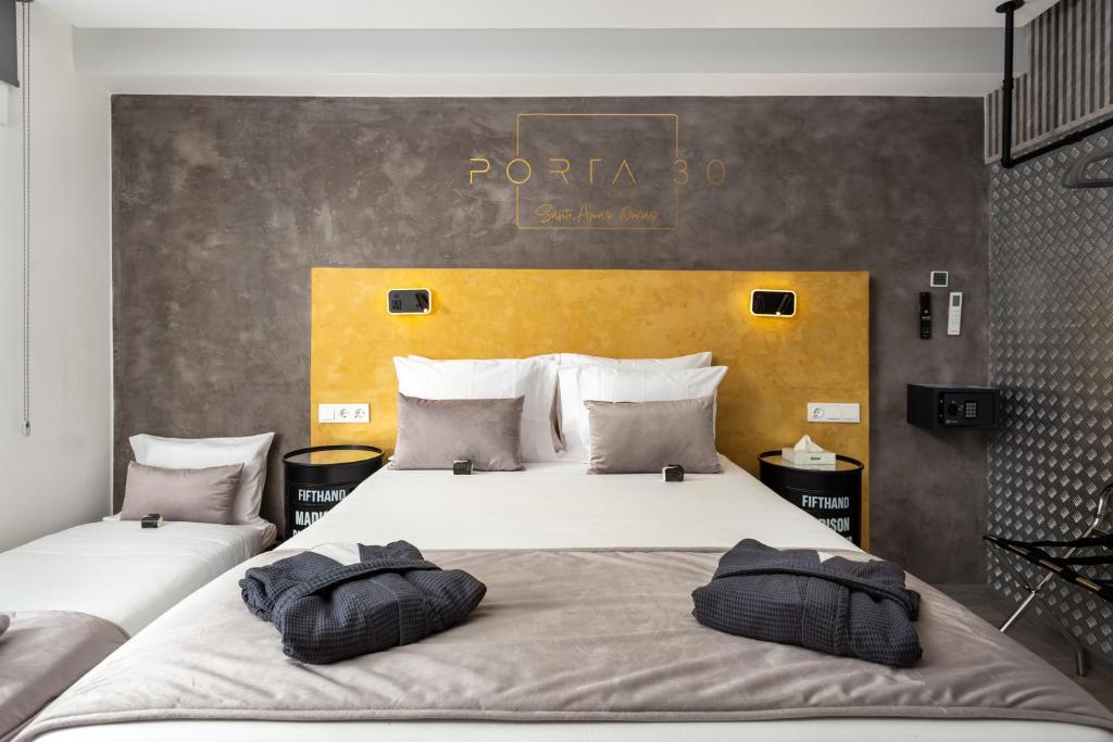 two pillows on a bed in a hotel room at Porta 30 in Oeiras