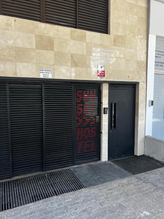 a building with two garage doors on the side of it at Sunset Hostel in Brasília