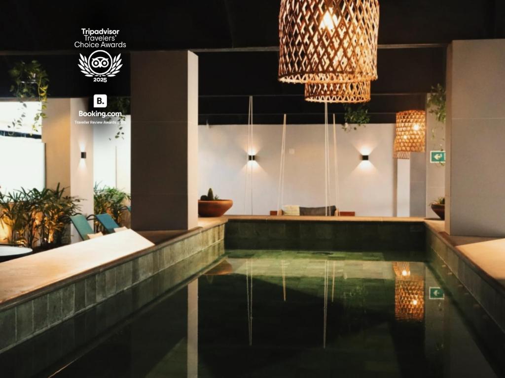 a swimming pool in a lobby with a chandelier at Kastel Petrópolis in Petrópolis