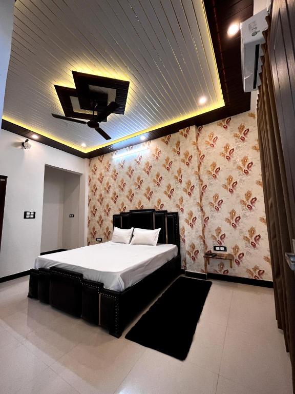 a bedroom with a bed and a tv on the ceiling at Green Valley Residency in Lucknow