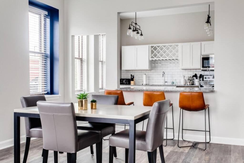 a kitchen and dining room with a table and chairs at Historic Elegance Modern Amenities Gym in Louisville