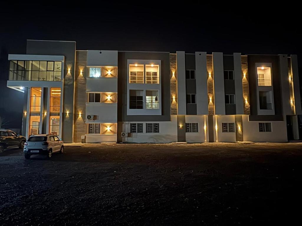 a building with a car parked in front of it at night at ENERGY Inn in Kotri Kalān