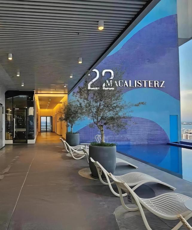 a lobby of a building with benches and a sign at Central Georgetown Studio with Nespresso Machine in George Town